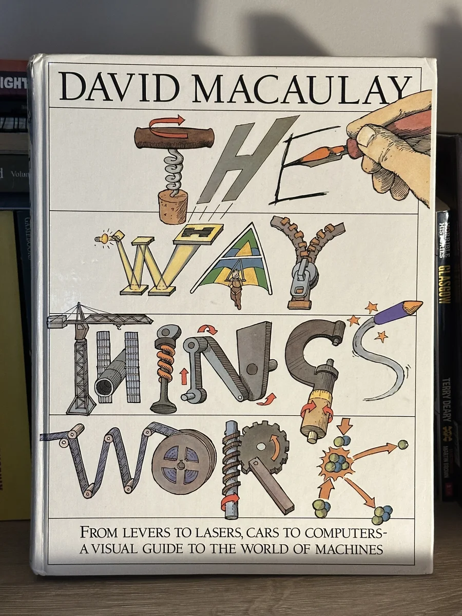 Drew's copy of The Way Things Work by David Macaulay, standing on a shelf between other books
